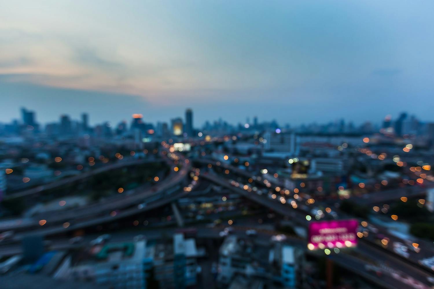 Blurred,Lights,Aerial,View,,City,And,Highway,Intersection,After,Sunset,